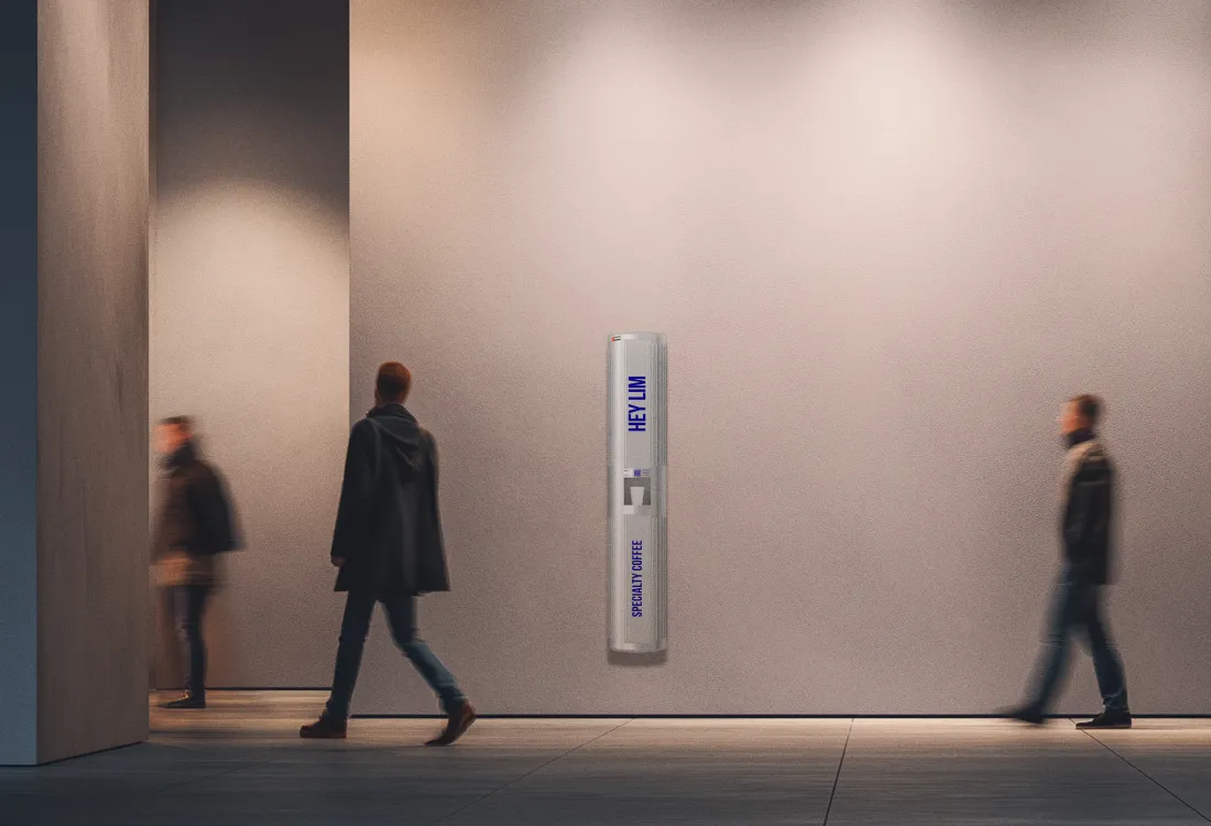 A HEYLIM coffee pillar standing in a quiet, minimal corridor